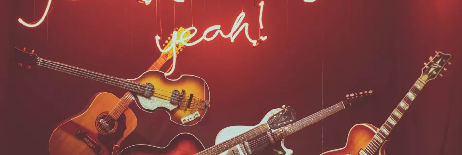 five assorted-color string guitars